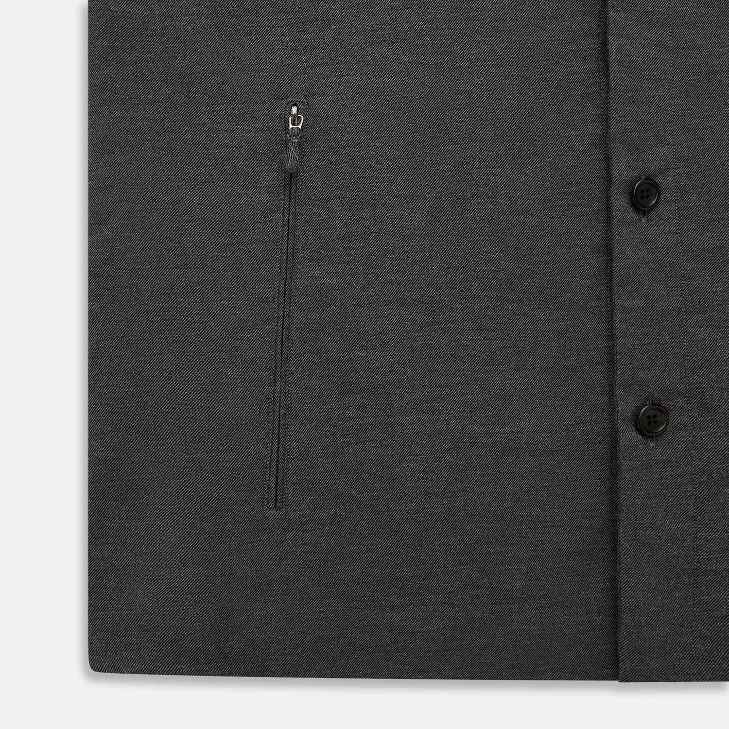 View 7 of product The Charcoal Melange Hampstead overshirt by Turnbull & Asser is a dark gray long-sleeve button-up with a collar, left chest pocket, and two zippered side pockets, shown laid flat on a white background.