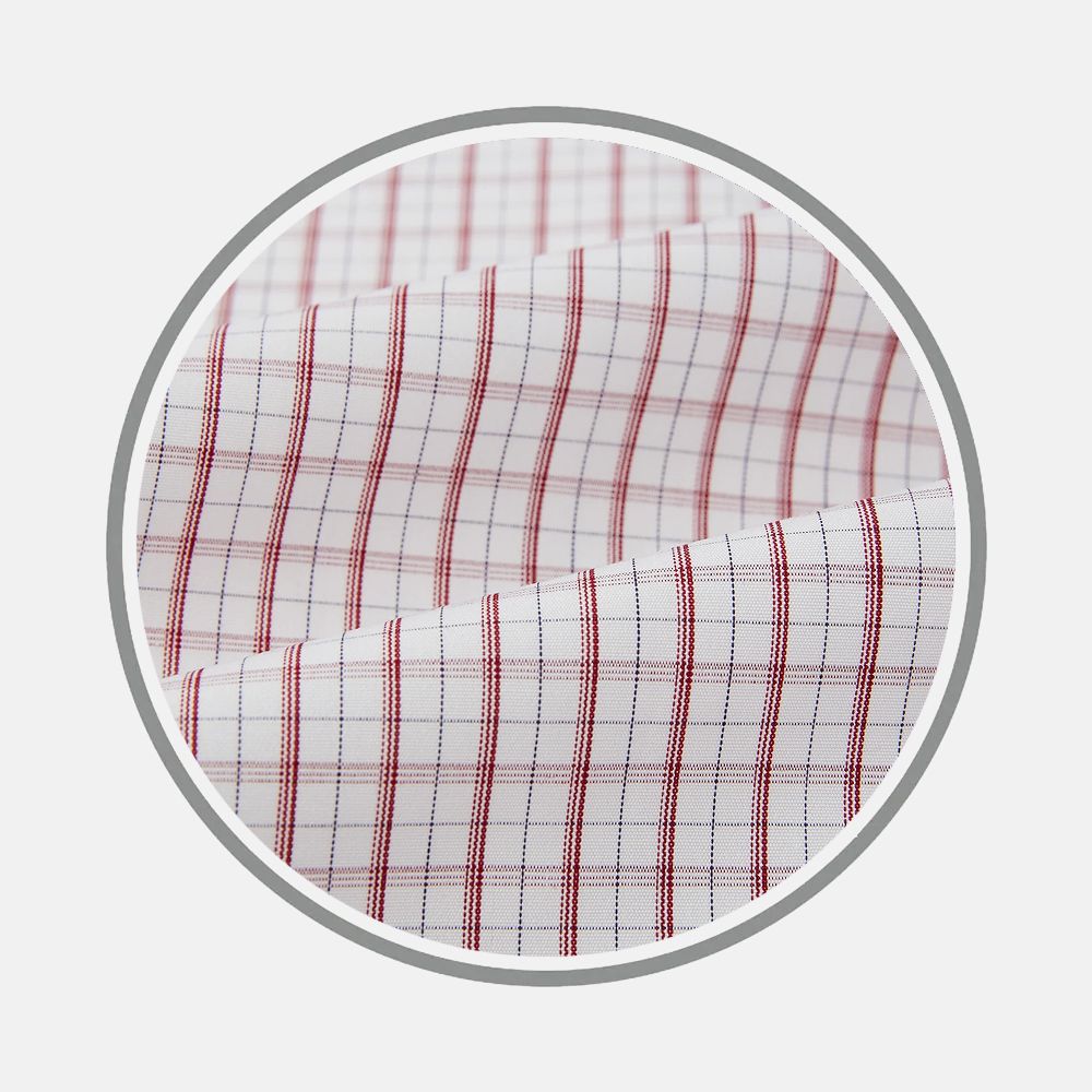 Close-up of Turnbull & Asser Red Tattersall Check Fabric, featuring a white background with thin red and blue intersecting lines forming a grid, displayed within a circular frame on a plain backdrop.