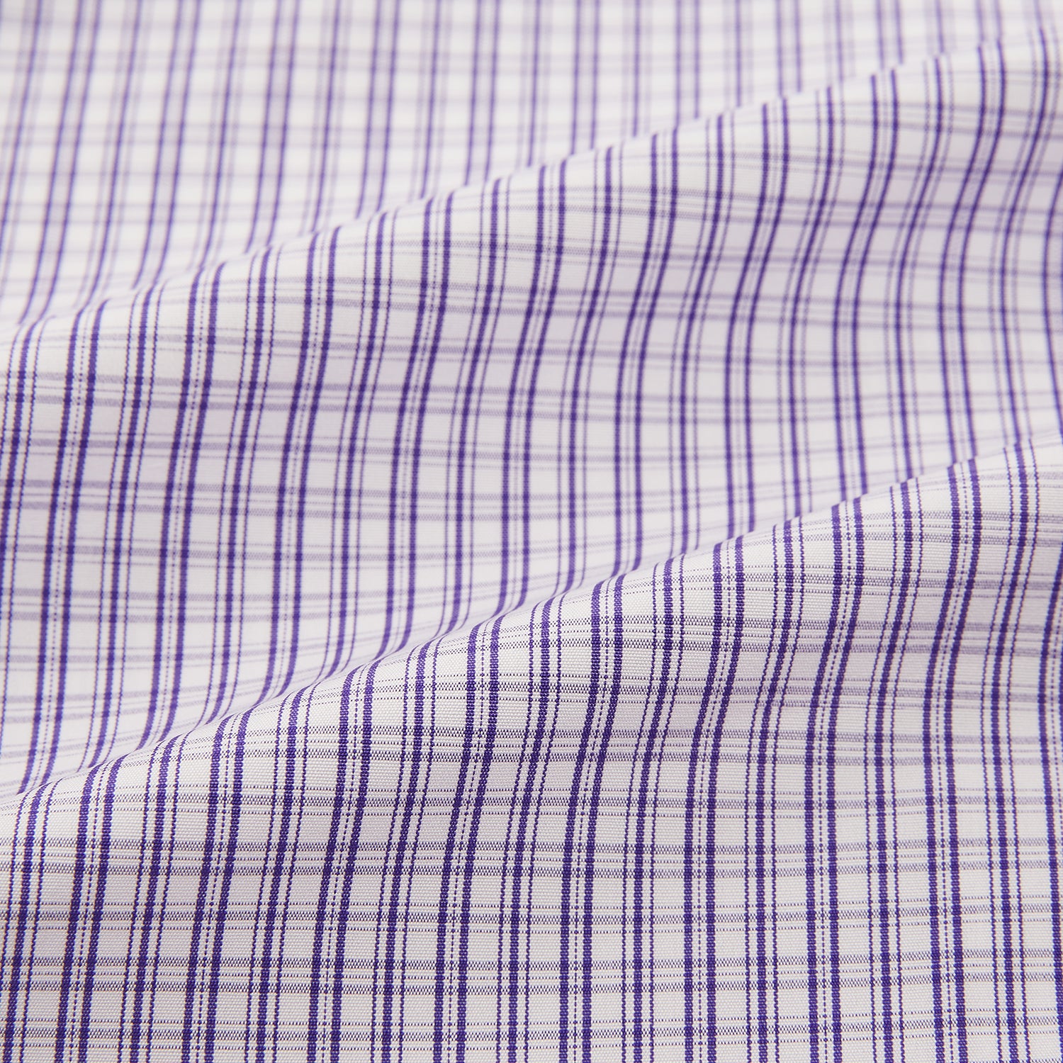 View 6 of product The Turnbull & Asser Purple Double Graph Check Mayfair Shirt is a long-sleeved, button-up dress shirt with a T&A collar and small blue and white check pattern, shown against a white background.