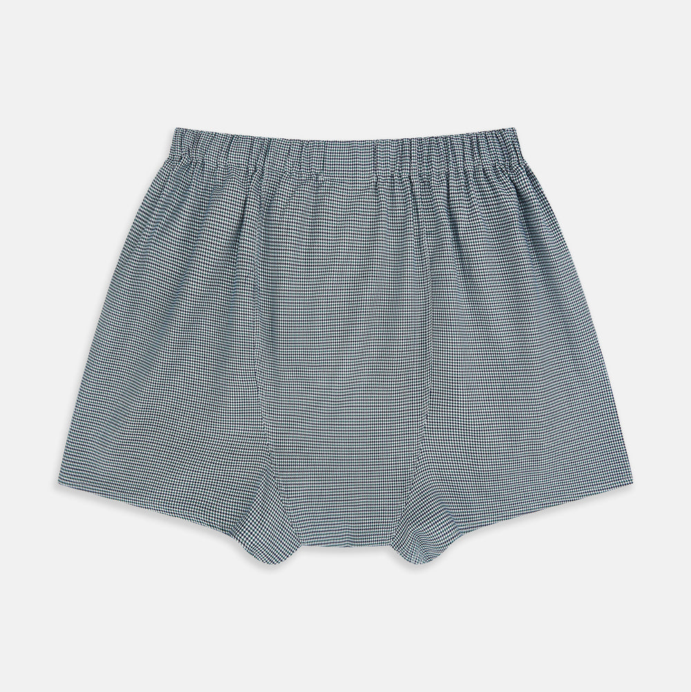 Turnbull & Asser Green Houndstooth Godfrey Boxer Shorts with an elastic waistband, showcasing a small black and white houndstooth pattern, are laid flat on a white background.