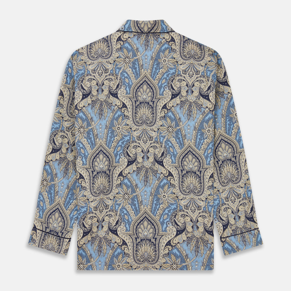 The Turnbull & Asser Pale Blue Baroque Silk-blend Hyde Pyjama Set features a long-sleeve button-up shirt and pants in a blue and beige paisley pattern, shown flat on a white background.