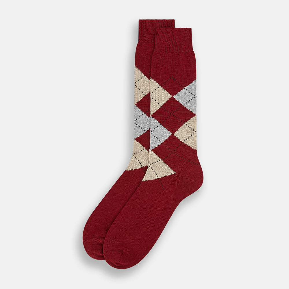 The Turnbull & Asser Burgundy Wool Check Mid-Length Sock features a dark red base with beige, white, and light brown argyle diamonds on the calf, shown against a plain white background.