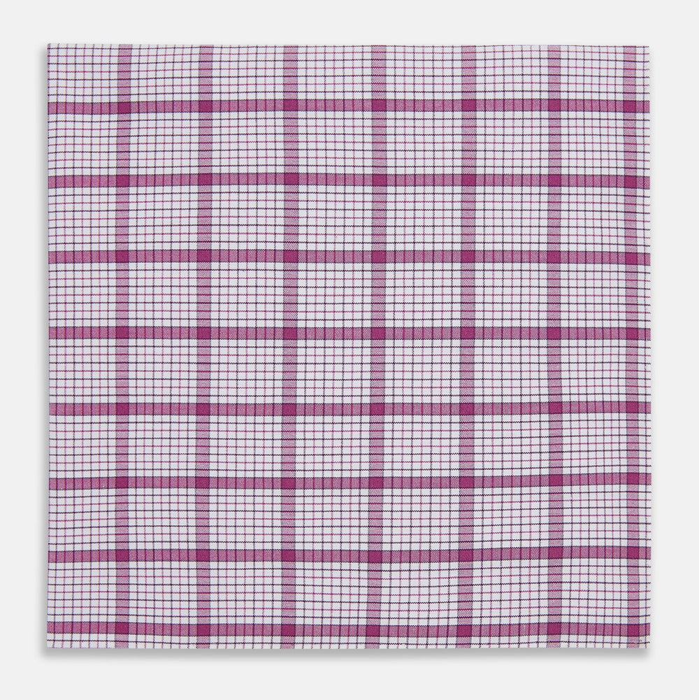 The Turnbull & Asser Hand Rolled Purple Graph Overlay Check Handkerchief is a white cotton accessory featuring intersecting purple and pink lines that create evenly spaced squares across the fabric.