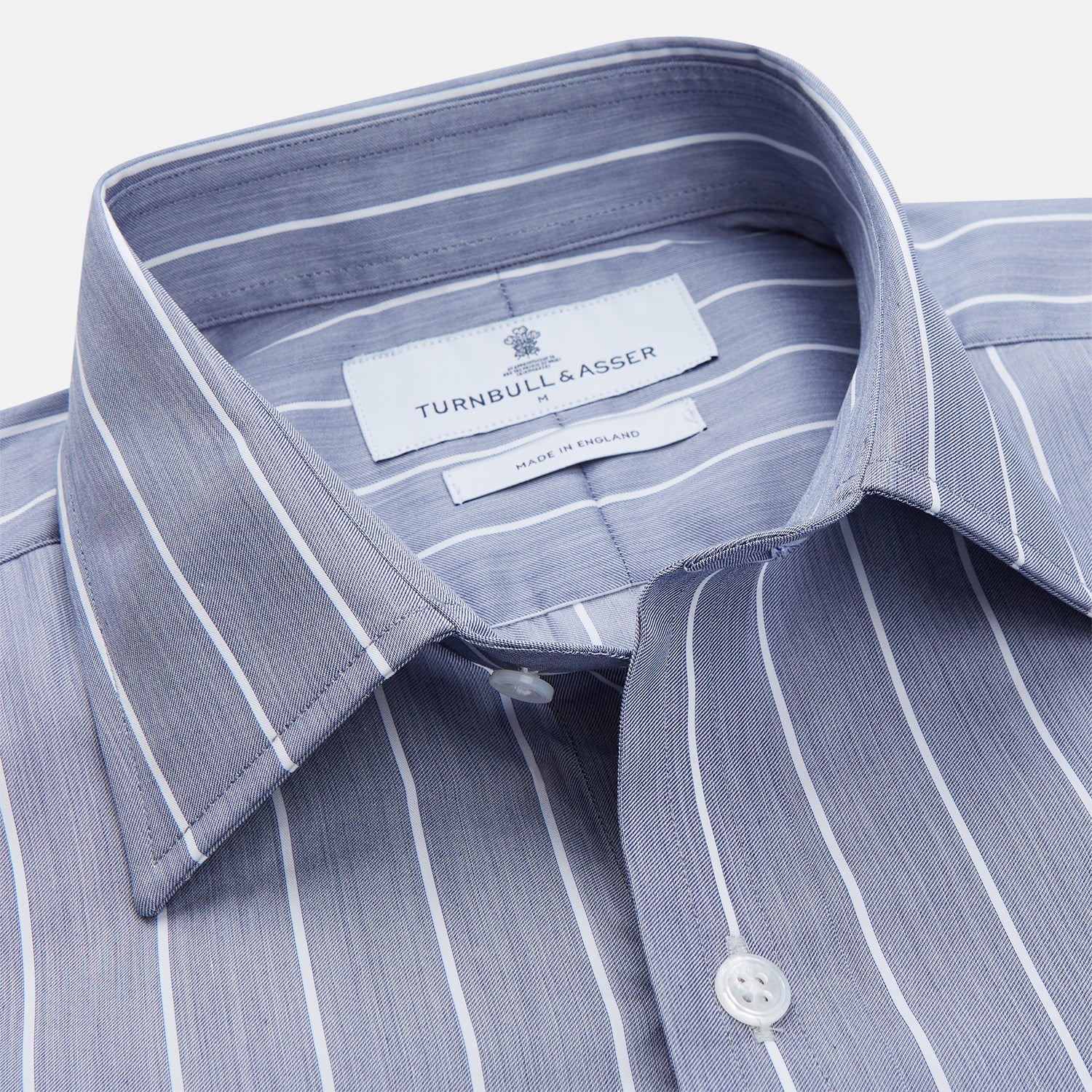 View 3 of product The Turnbull & Asser Pale Blue and White Pinstripe Cotton Blend Weekend Fit Finch Shirt features long sleeves, a chest pocket, and white buttons—ideal for classic, casual style. Shown laid flat on a white background.