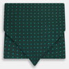 View 1 of product The Turnbull & Asser Blue and Forest Green Micro Dot Silk Cravat pairs perfectly with a dark green pocket square featuring light blue micro dots, ideal for formal looks or adding distinction to your ensemble.