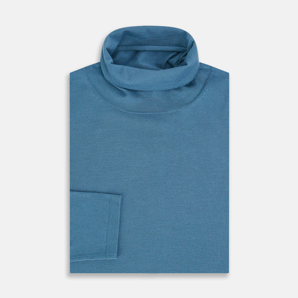 Turnbull & Asser's Pale Blue Fine Merino High Neck Jumper is shown on a plain white background, featuring a simple, classic design with long sleeves and no visible patterns or embellishments.