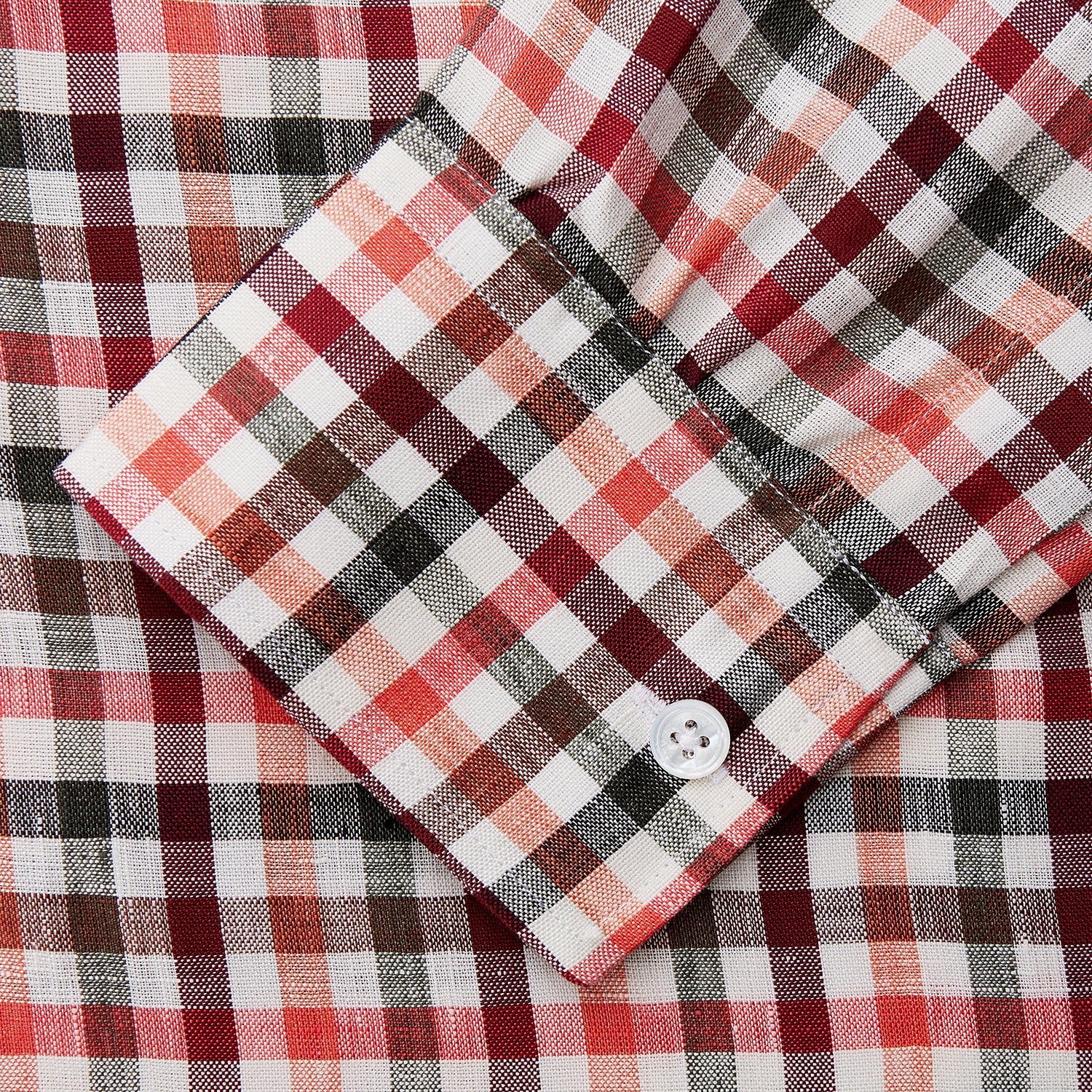 View 3 of product The Turnbull & Asser Red and Green Check Linen Blend Weekend Fit Hayne Shirt features a classic plaid pattern in red, white, black, and green, with a Dorset button-down collar and long sleeves. Displayed on a white background.