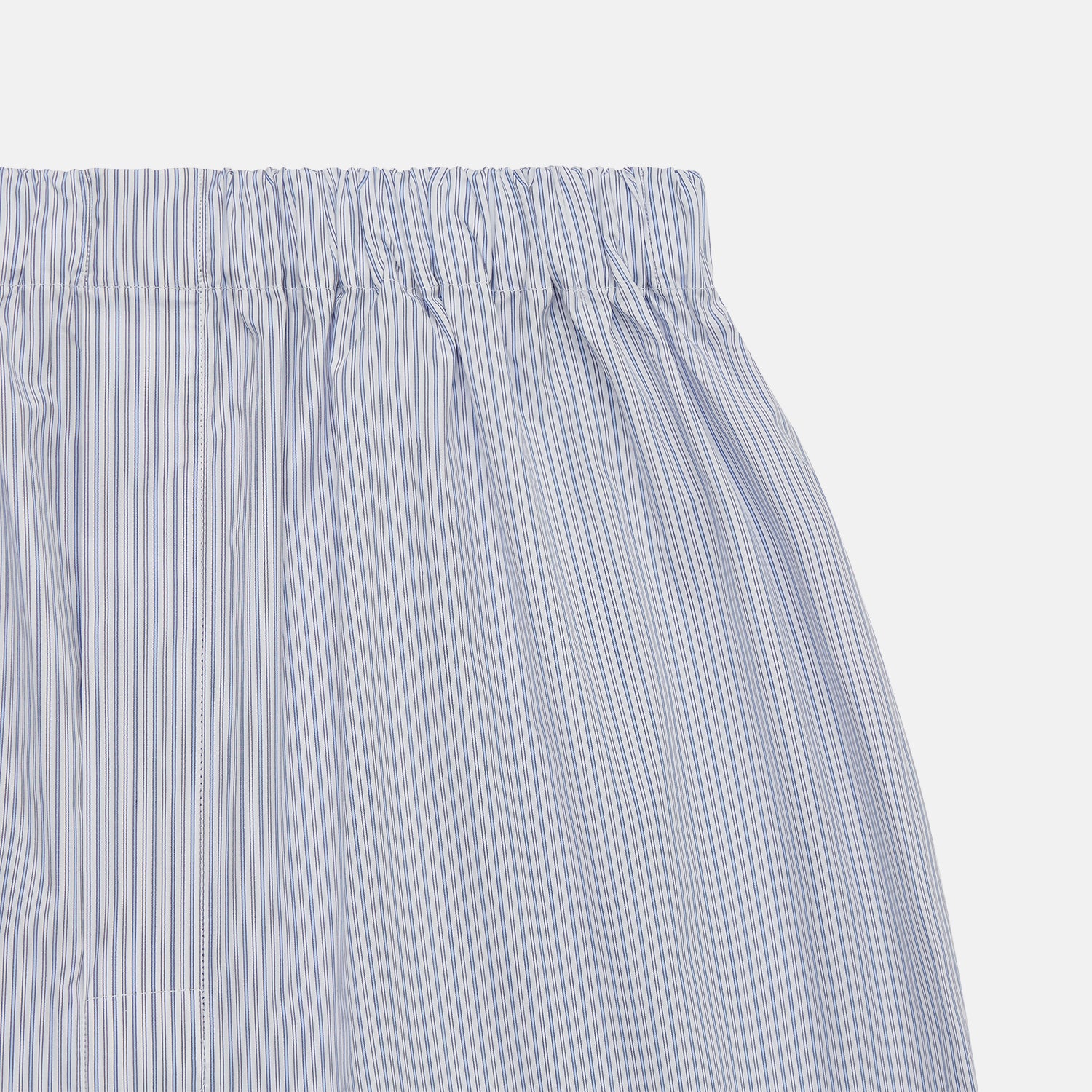 View 2 of product Turnbull & Asser Blue Multi Stripe Cotton Godfrey Boxer Shorts feature light blue and white stripes, an elastic waistband, and soft cotton fabric—perfect for those who value luxury underwear. Laid flat on a plain white background.