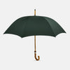 View 1 of product The Forest Green Umbrella with Whangee Crook Handle by Turnbull & Asser features a wooden shaft and classic curved handle—a sophisticated men’s accessory shown fully opened against a white background.