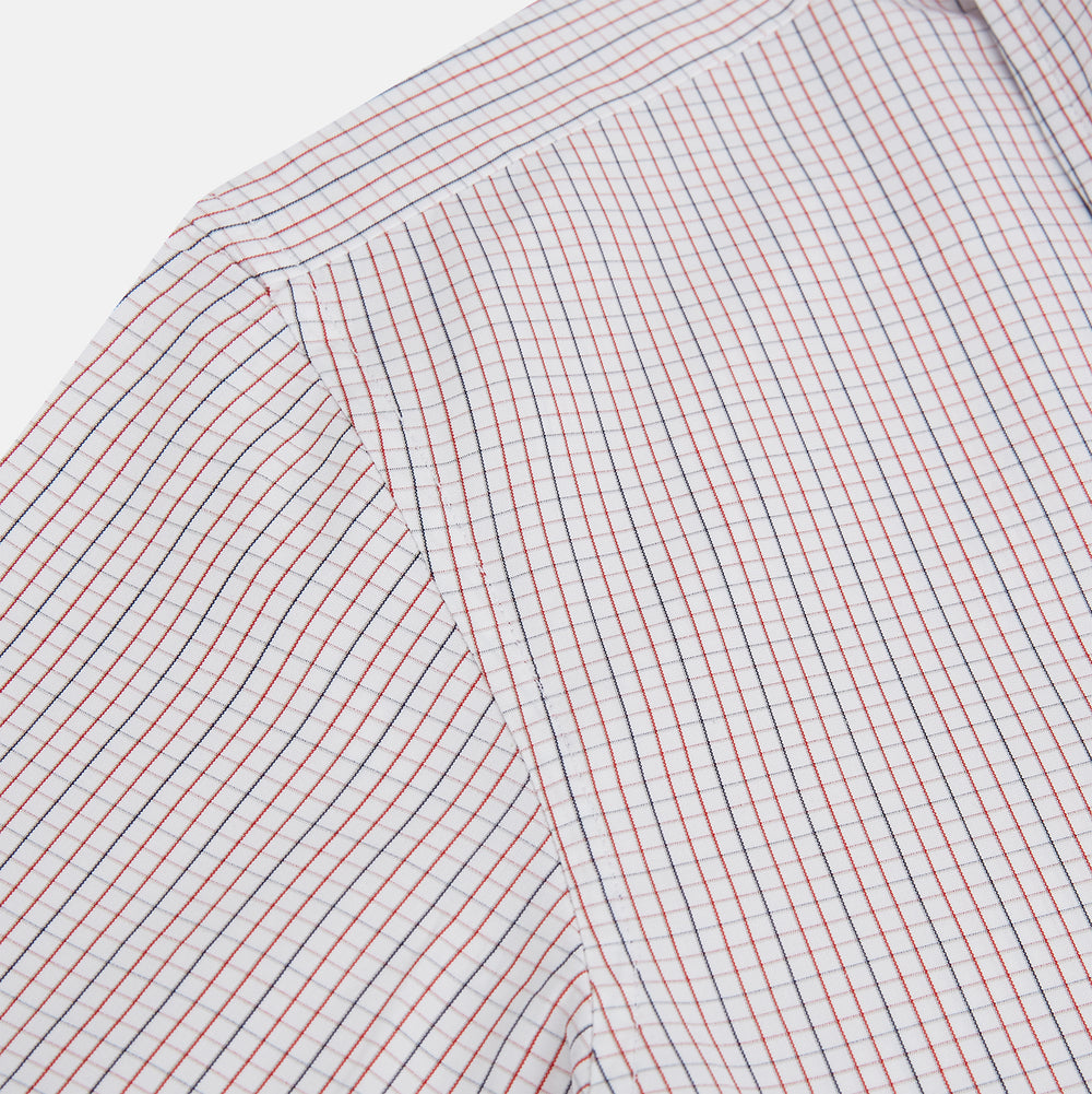 The Turnbull & Asser Red and Navy Check Windsor Shirt features a pointed collar and cuffed long sleeves, highlighting British craftsmanship. Displayed flat on a white background.