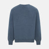 View 3 of product The Turnbull & Asser Pacific Blue Cashmere Round Neck Jumper features long sleeves and ribbed cuffs, hem, and neckline, shown on a light grey background.