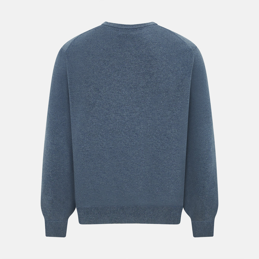 The Turnbull & Asser Pacific Blue Cashmere Round Neck Jumper features long sleeves and ribbed cuffs, hem, and neckline, shown on a light grey background.