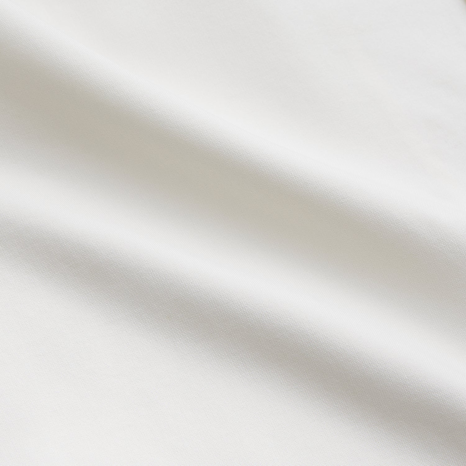 View 3 of product The Cream Silk Holiday Fit Phillips Shirt by Turnbull & Asser is a short-sleeved, collared silk shirt in off-white with three front pockets and a revere collar, displayed flat on a plain white background.