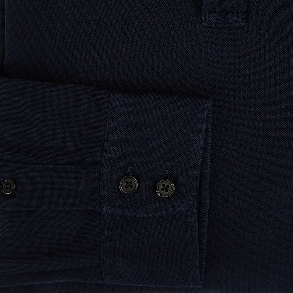 A Navy Rugby Polo Shirt by Turnbull & Asser, featuring long sleeves and a collar, is displayed flat on a white background. The design is simple and free of visible logos or patterns.