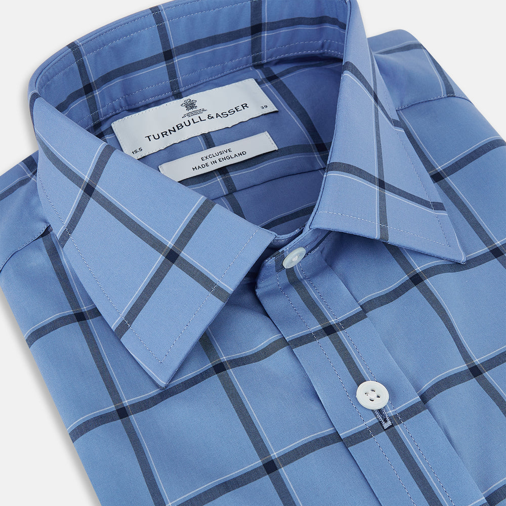 The Turnbull & Asser Colony Blue Grid Check Mayfair Shirt is a light blue, long-sleeve button-up with a collar and evenly spaced dark blue grid lines.