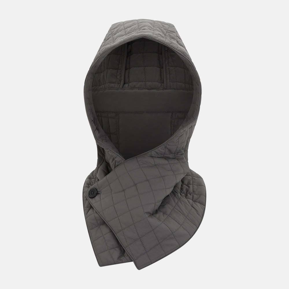 The Turnbull & Asser Shadow Grey Quilted Hood with Neck Warmer features a button closure, inspired by quilted jacket hoods, and is displayed on a plain white background.