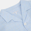 View 2 of product The Turnbull & Asser Blue Prince of Wales Check Pyjama Shirt features long sleeves, a notched collar, a left chest pocket, and a subtle check pattern, shown laid flat on a white background.