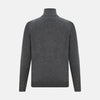 View 3 of product The Turnbull & Asser Charcoal Grey Melange Half-Zip Cashmere Jumper features a high collar, quarter-zip design, and long sleeves, shown against a plain white background.