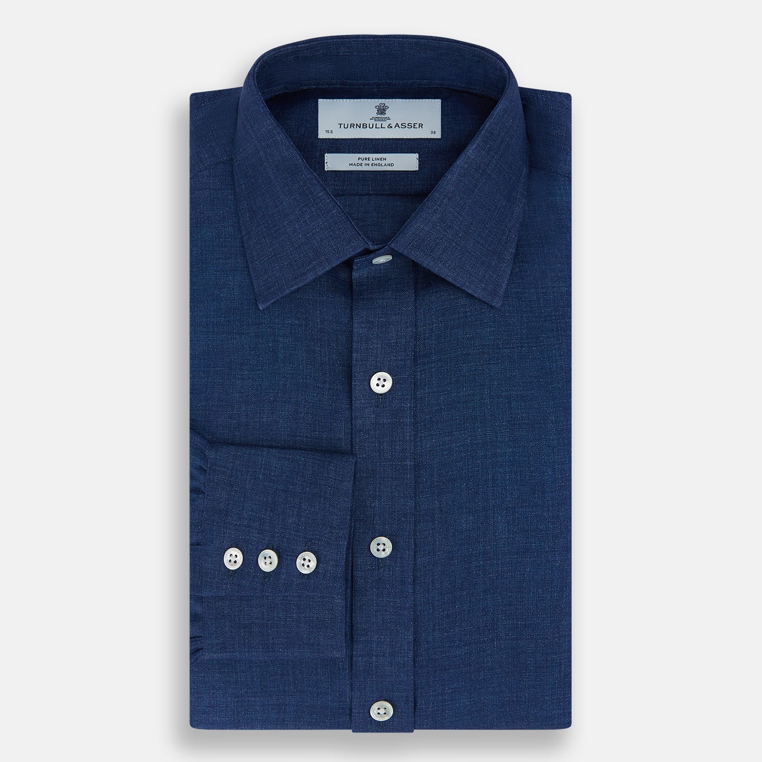 View 5 of product The Turnbull & Asser Navy Linen Mayfair Shirt features long sleeves, a button-up front with white buttons, pointed collar, buttoned cuffs, and a classic fit in solid dark blue linen, shown on a white background.
