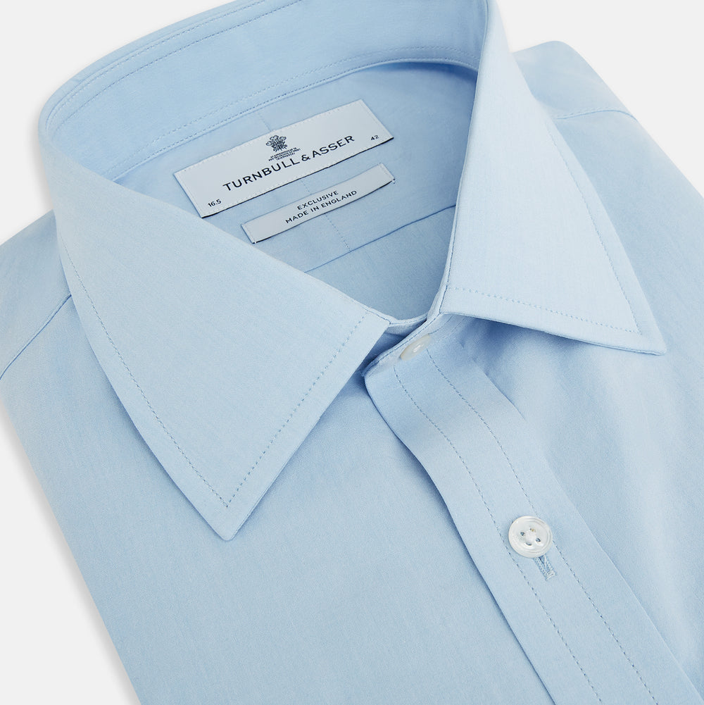 The Turnbull & Asser Sky Blue Mayfair Shirt is a long-sleeved, collared button-down made from sanforised cotton, shown laid flat on a white background.