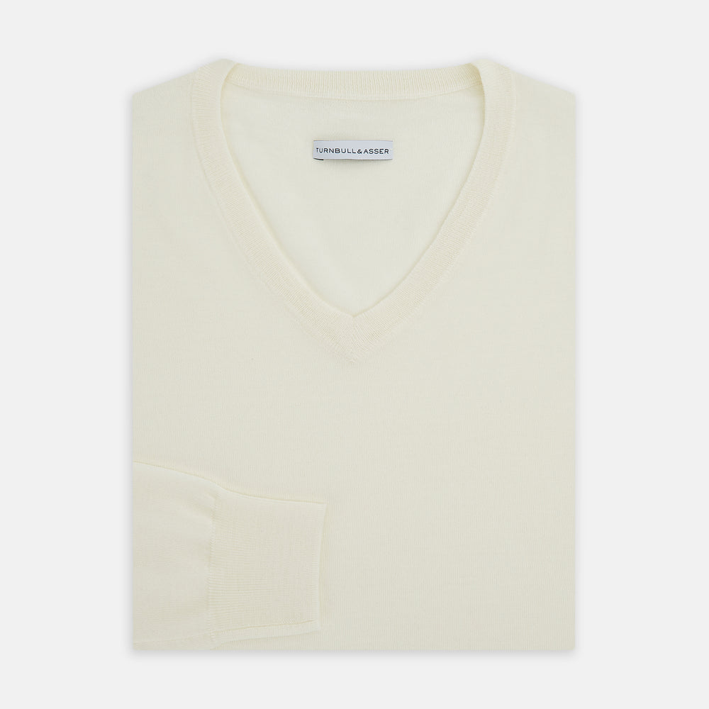 The Turnbull & Asser White Fine Merino V-Neck Jumper, shown against a white background, features a timeless design with long sleeves and ribbed cuffs and hem.