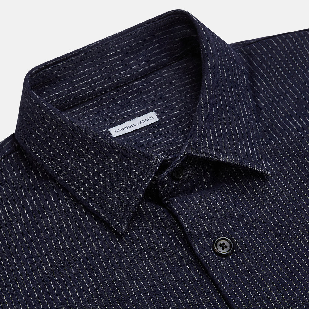 The Turnbull & Asser Navy Stripe Hampstead Overshirt features pinstripes, a collar, long sleeves, chest pocket, and two angled side pockets—ideal for refining your formal look. Shown laid flat on a light background.