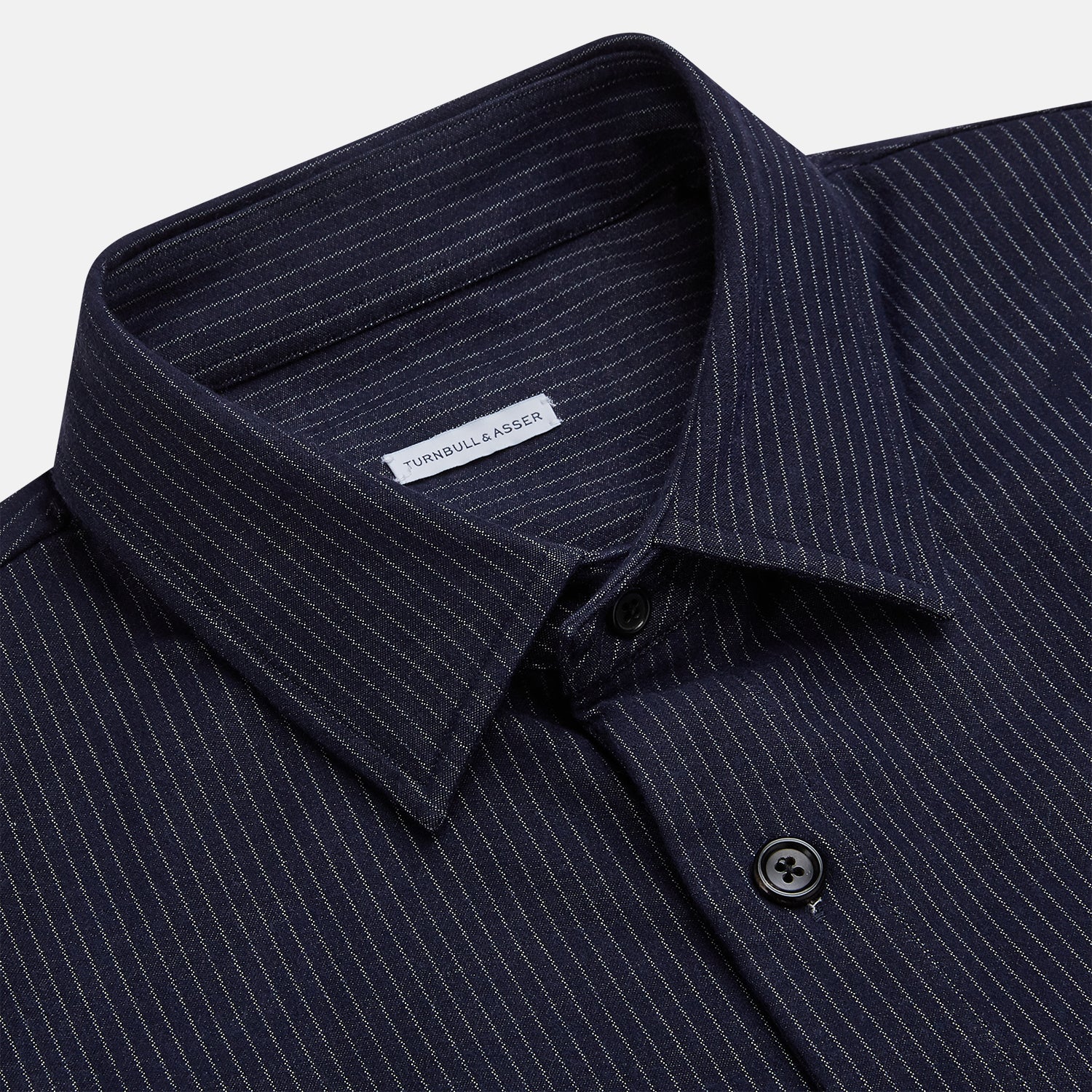 View 2 of product The Turnbull & Asser Navy Stripe Hampstead Overshirt features pinstripes, a collar, long sleeves, chest pocket, and two angled side pockets—ideal for refining your formal look. Shown laid flat on a light background.