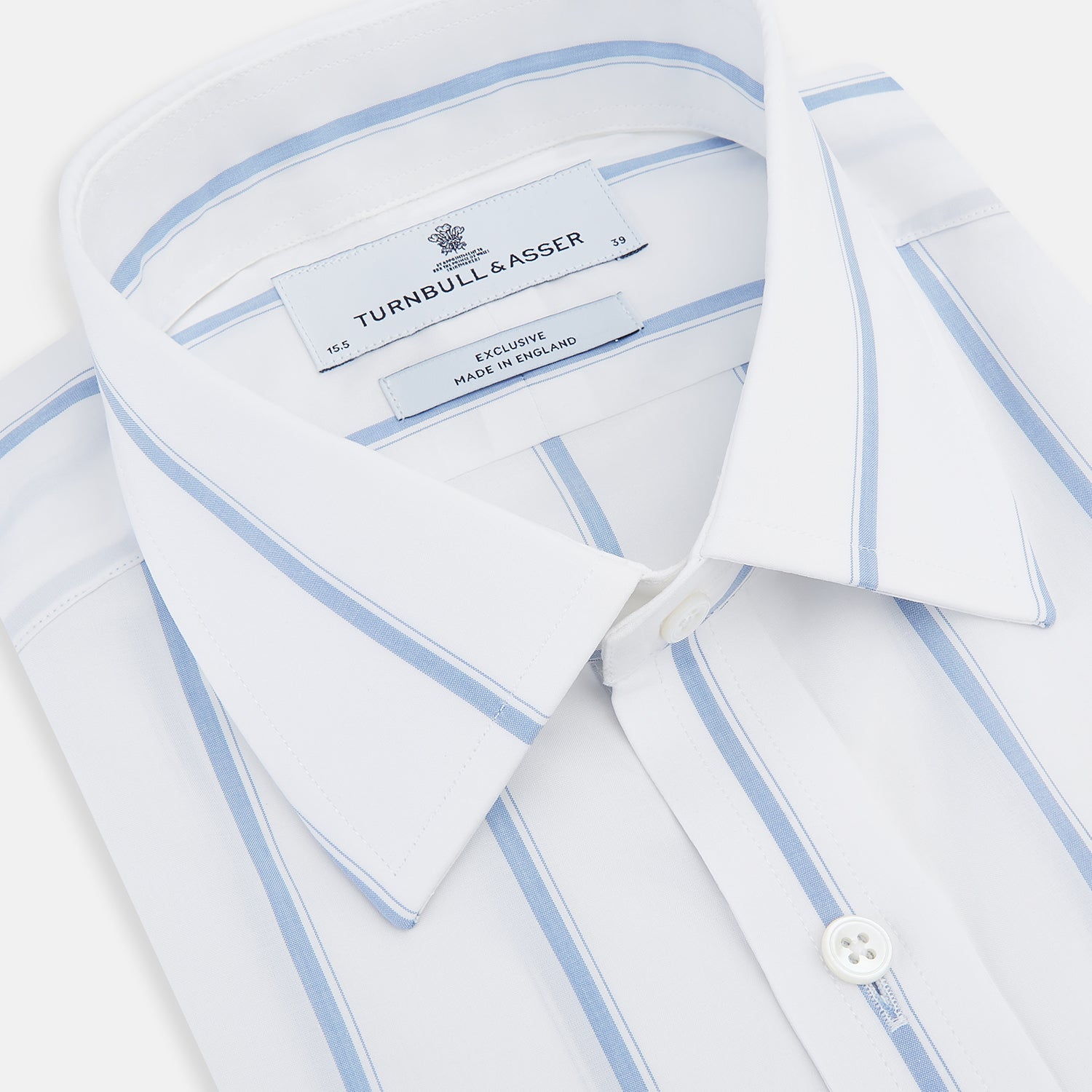 View 2 of product The Colony Blue Track Stripe Mayfair Shirt by Turnbull & Asser is a long-sleeve, button-up Italian cotton shirt with a white base and blue stripes, pointed collar, and buttoned cuffs, shown laid flat on a white background.
