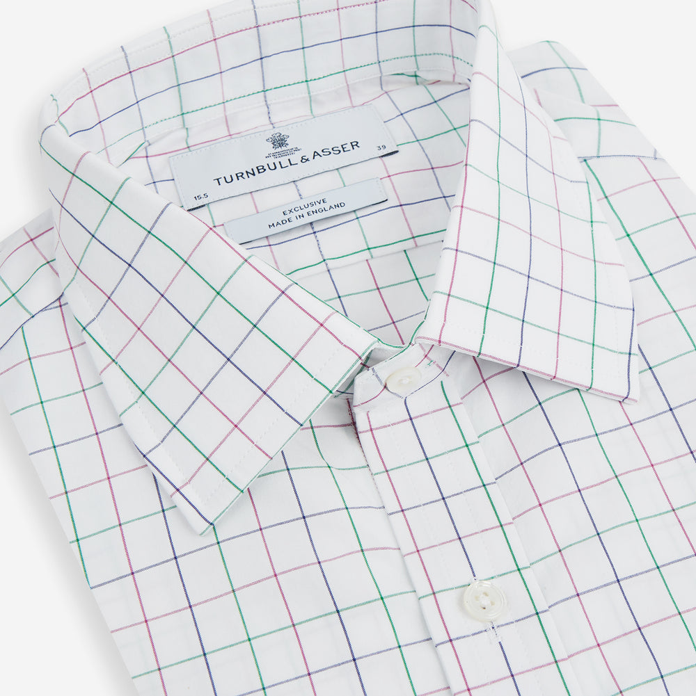 The Turnbull & Asser Pink Grid Check Mayfair Shirt is a long-sleeve, button-down shirt with a T&A collar, crafted from organic cotton and featuring a pink checkered grid pattern on white with buttoned cuffs.
