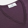 View 2 of product The Turnbull & Asser Plum Kennedy Merino V-Neck Jumper is a long-sleeved knitwear piece made from soft Italian wool, shown laid flat on a white background.