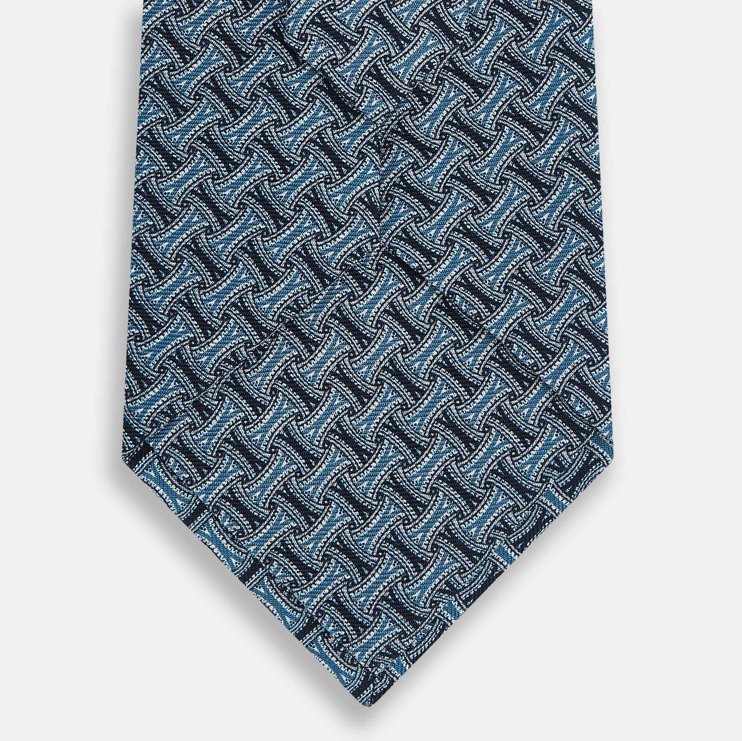 View 3 of product A close-up of the Turnbull & Asser Pale Blue and Navy Weave Patterned Silk Tie, featuring a textured geometric design. The silk tie is rolled at one end and displayed on a white background.
