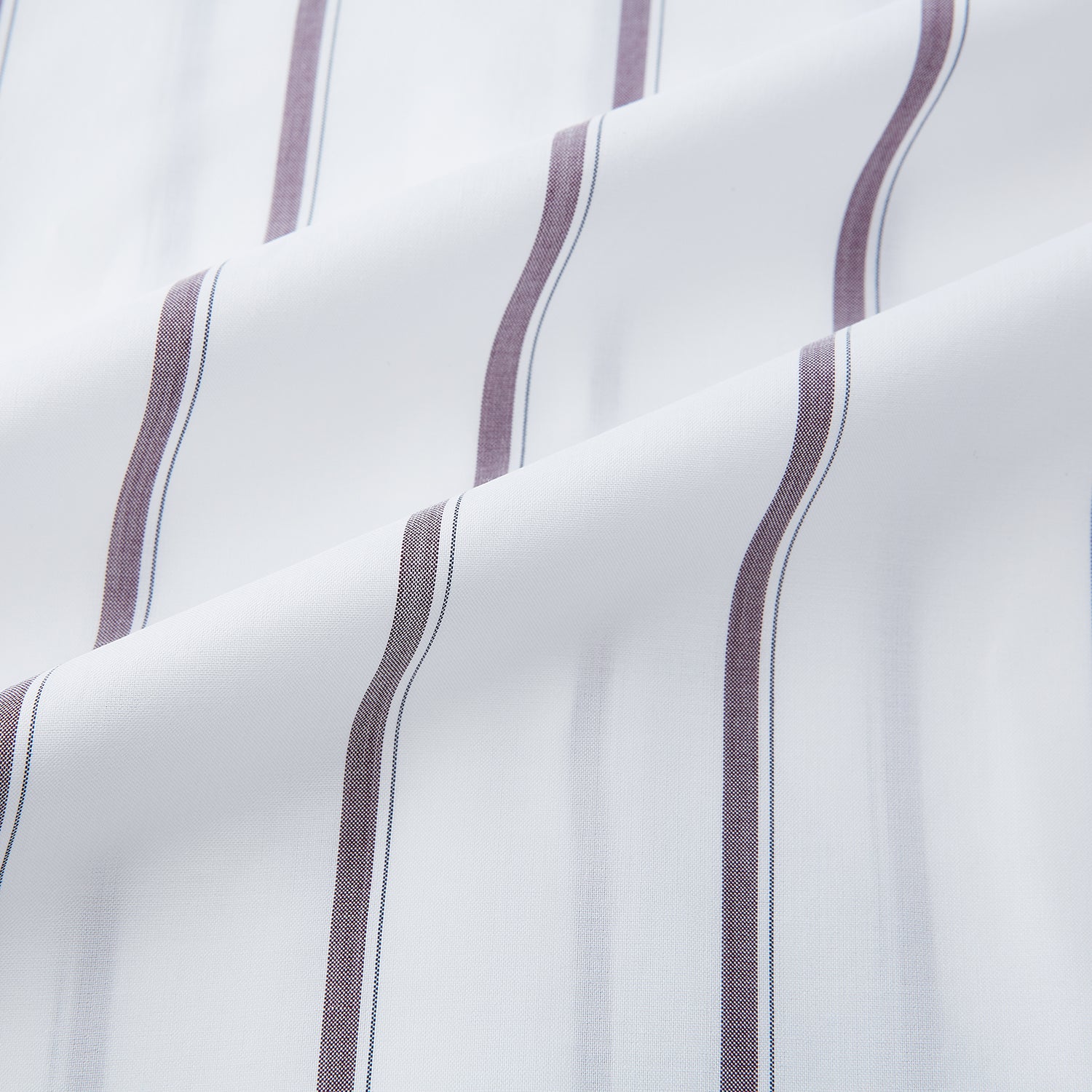 View 6 of product A Burgundy Track Stripe Mayfair Shirt by Turnbull & Asser, featuring long sleeves, vertical stripes, a classic collar, and crafted from premium Italian cotton, is displayed flat on a light background.