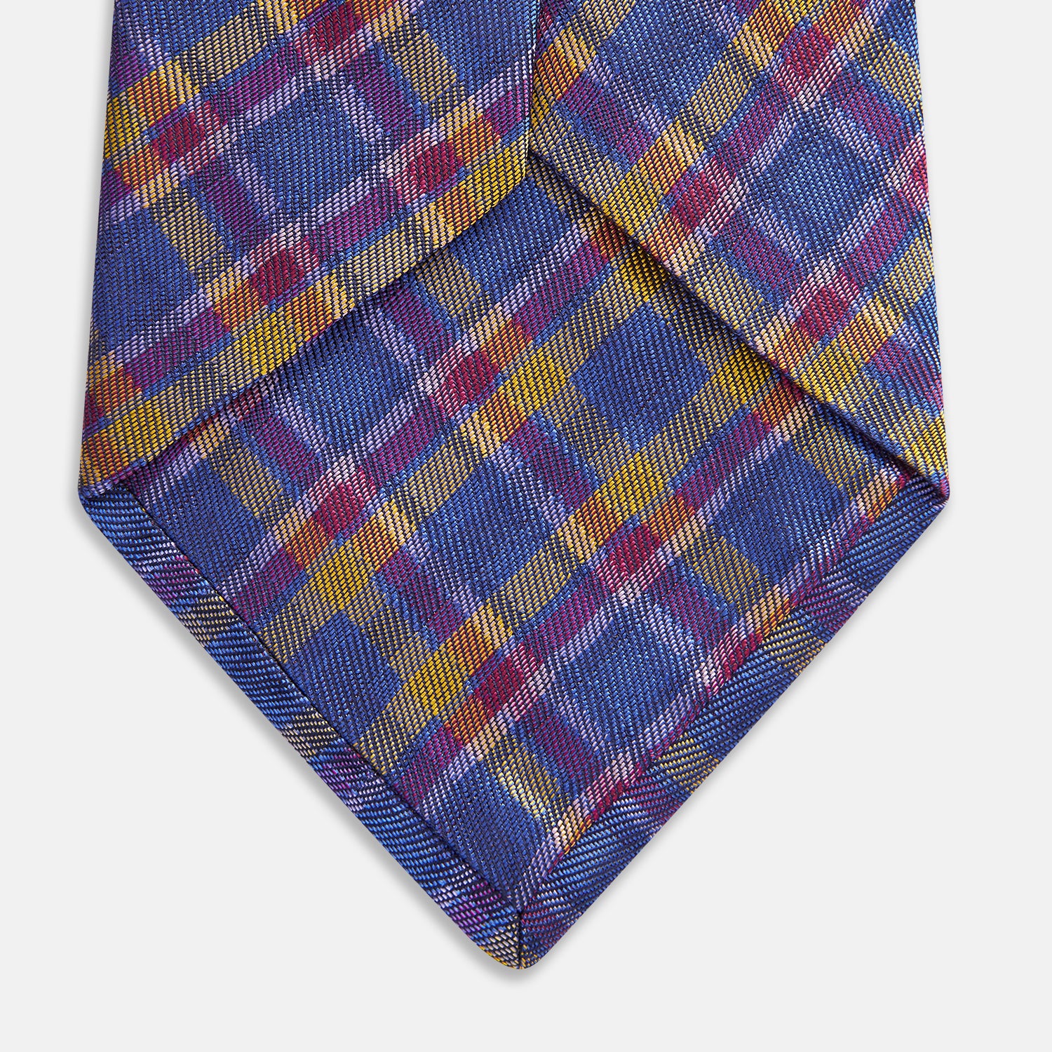 View 3 of product The Turnbull & Asser Blue Multi Tartan Silk Tie features a vibrant blue, yellow, and pink plaid pattern and is shown rolled up on a white background.