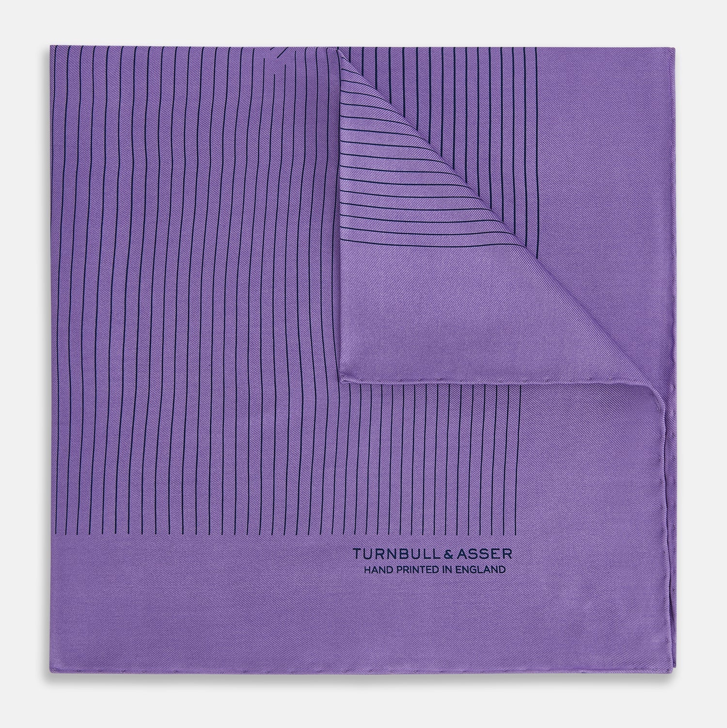 View 1 of product The Purple Stripe Silk Pocket Square by Turnbull & Asser features thin black lines on purple silk—a sophisticated blazer accessory hand printed in England, showcasing classic British craftsmanship.