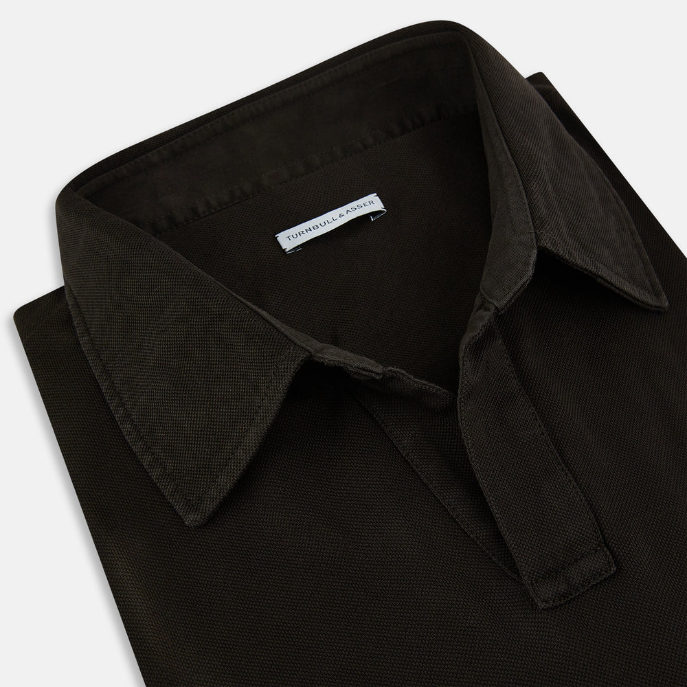 A brown Rugby Polo Shirt by Turnbull & Asser, made of pure cotton with long sleeves, a collar, and a short buttonless placket, is laid flat on a white background.