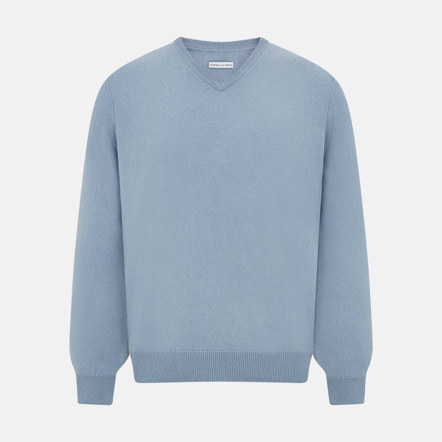 View 1 of product The Turnbull & Asser Frost Blue Cashmere V-Neck Jumper features ribbed cuffs, hem, and neckline. This elegant long sleeve knitwear piece is shown on a plain white background.
