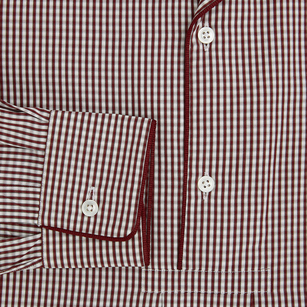 The Turnbull & Asser Burgundy Micro Check Winston Long Nightshirt is knee-length with long sleeves, brown and white micro checks, a collar, chest pocket with piping, and a front button placket.