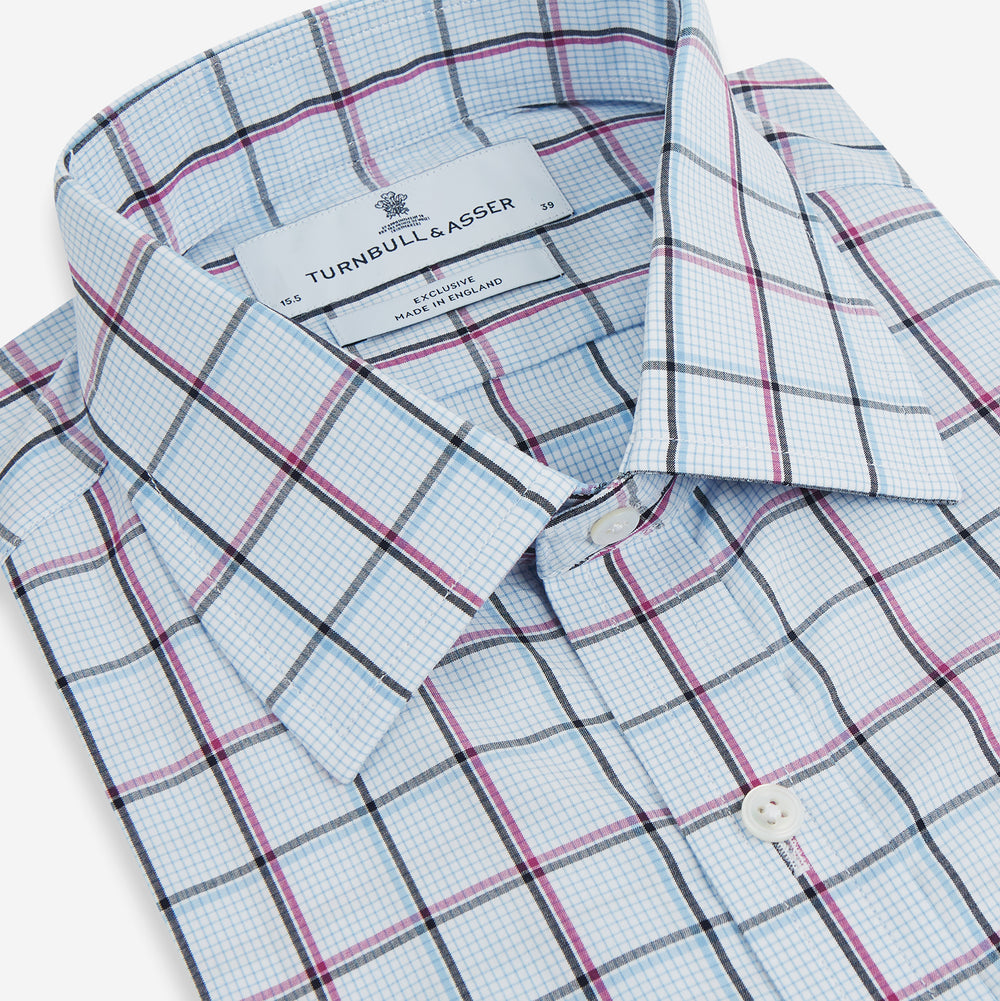 The Turnbull & Asser Blue and Pink Tattersall Check Mayfair Shirt features a classic tattersall pattern with a T&A collar and cuffed sleeves.