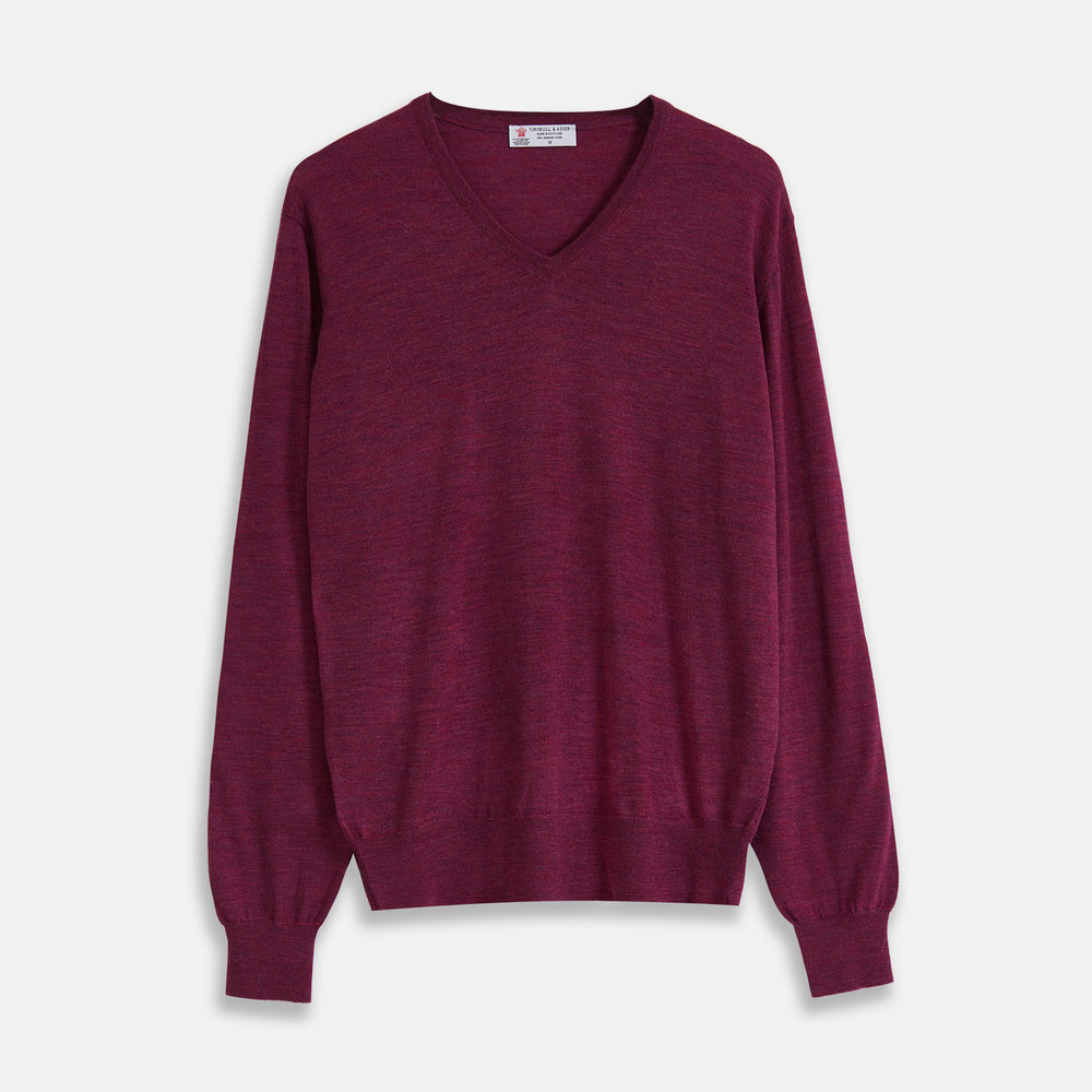 The Turnbull & Asser Plum Fine Merino V-Neck Jumper is a lightweight, long-sleeved layer in deep burgundy, featuring ribbed cuffs and hem for a refined finish, displayed against a white background.