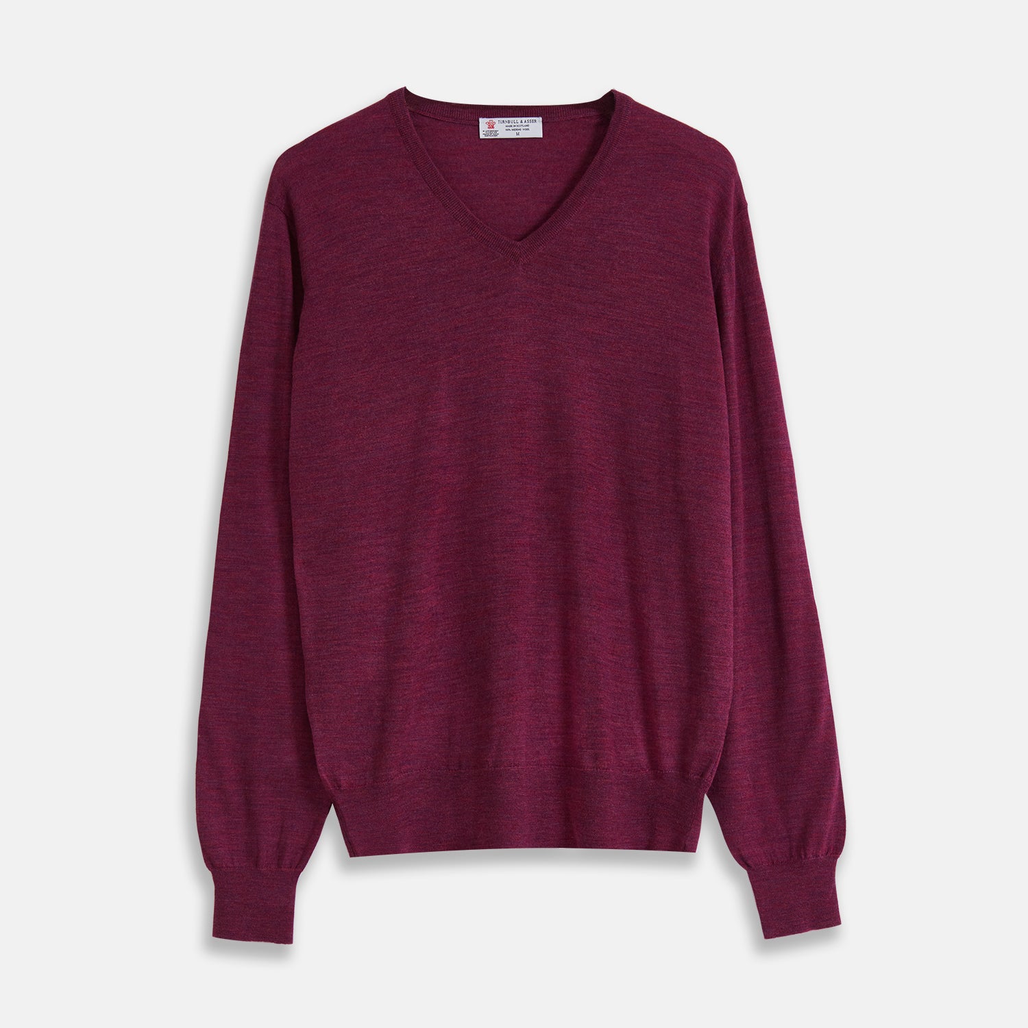 View 1 of product The Turnbull & Asser Plum Fine Merino V-Neck Jumper is a lightweight, long-sleeved layer in deep burgundy, featuring ribbed cuffs and hem for a refined finish, displayed against a white background.