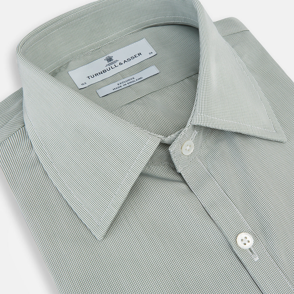 A dark green micro graph check Westminster shirt by Turnbull & Asser, featuring fine British craftsmanship, a Turnbull collar, and white buttons, is laid flat on a white background.