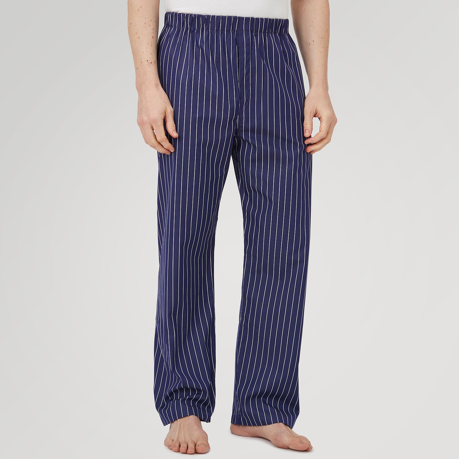 View 2 of product Turnbull & Asser Navy Stripe Modern Pyjama Trousers in superfine cotton with white stripes, elastic waistband, and relaxed fit, presented against a plain white background.