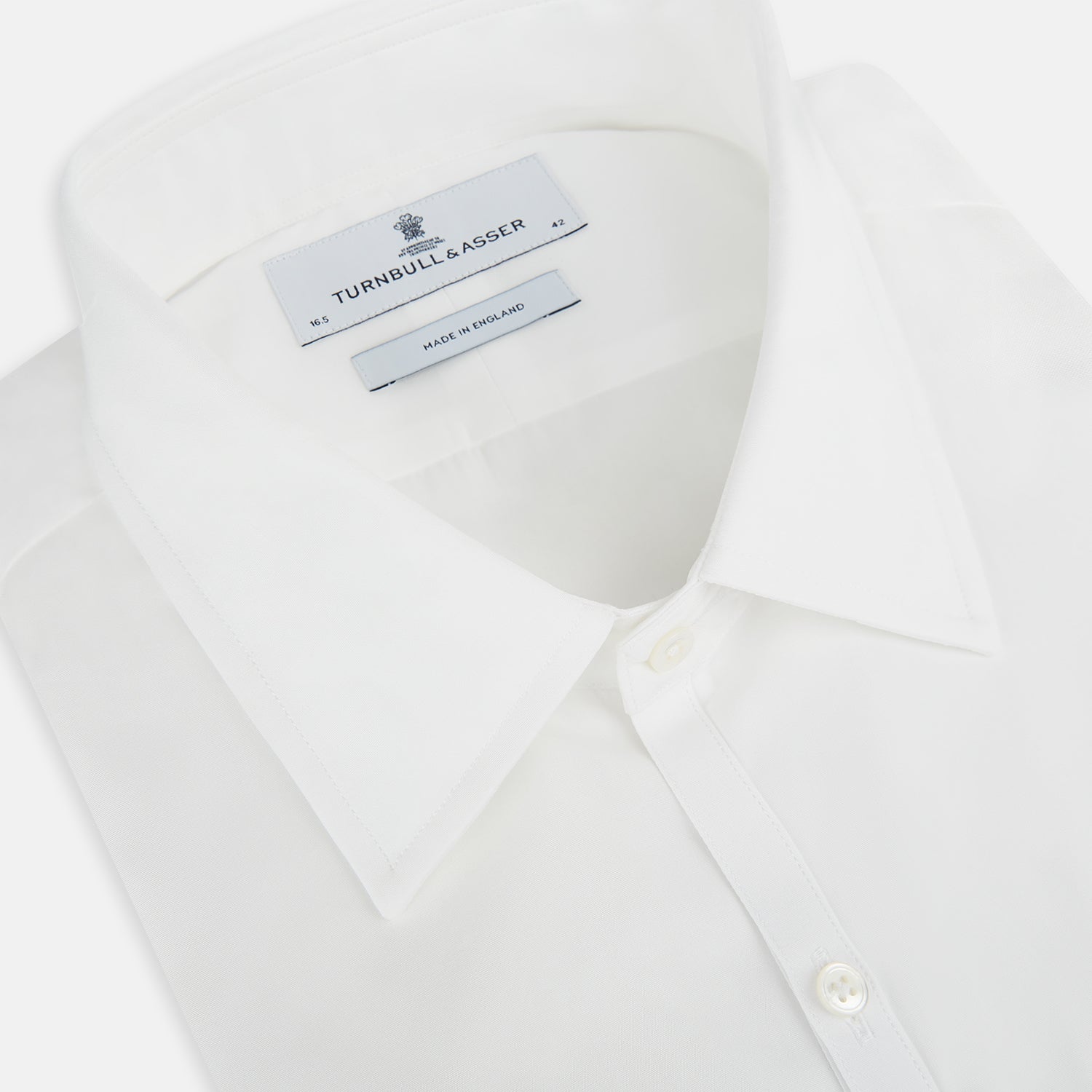 View 2 of product The PLAIN WHITE WESTMINSTER SHIRT WITH TURNBULL COLLAR AND 3-BUTTON CUFFS by Turnbull & Asser features refined British craftsmanship, long sleeves, a straight hem, and a crisp white design displayed on a plain background.