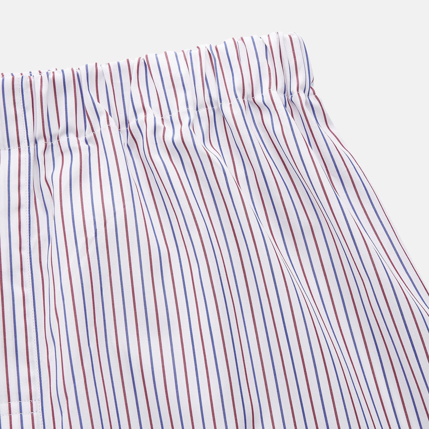 View 2 of product The Turnbull & Asser Red and Blue Stripe Cotton Hastings Pyjama Trousers feature a loose fit with an elastic waistband for comfort, showcasing bold red and blue stripes on soft cotton, displayed against a plain white background.