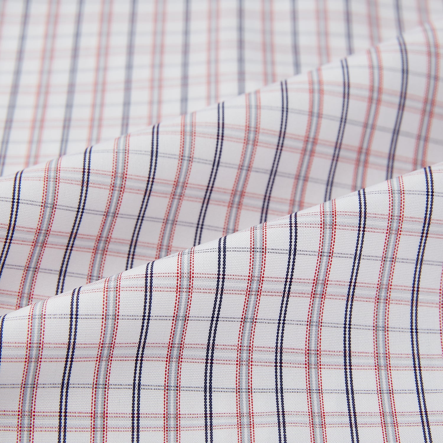 View 6 of product The Turnbull & Asser Red and Blue Multi Check Mayfair Shirt is a long-sleeve button-down made from Italian cotton with a white base and a light red and blue check pattern, shown laid flat on a white background.