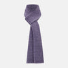 View 1 of product The Turnbull & Asser Purple and Lilac Hexagon Cashmere Knitted Scarf, featuring a white hexagon pattern, is neatly knotted and displayed on a plain background—a stylish accessory to elevate any outfit.