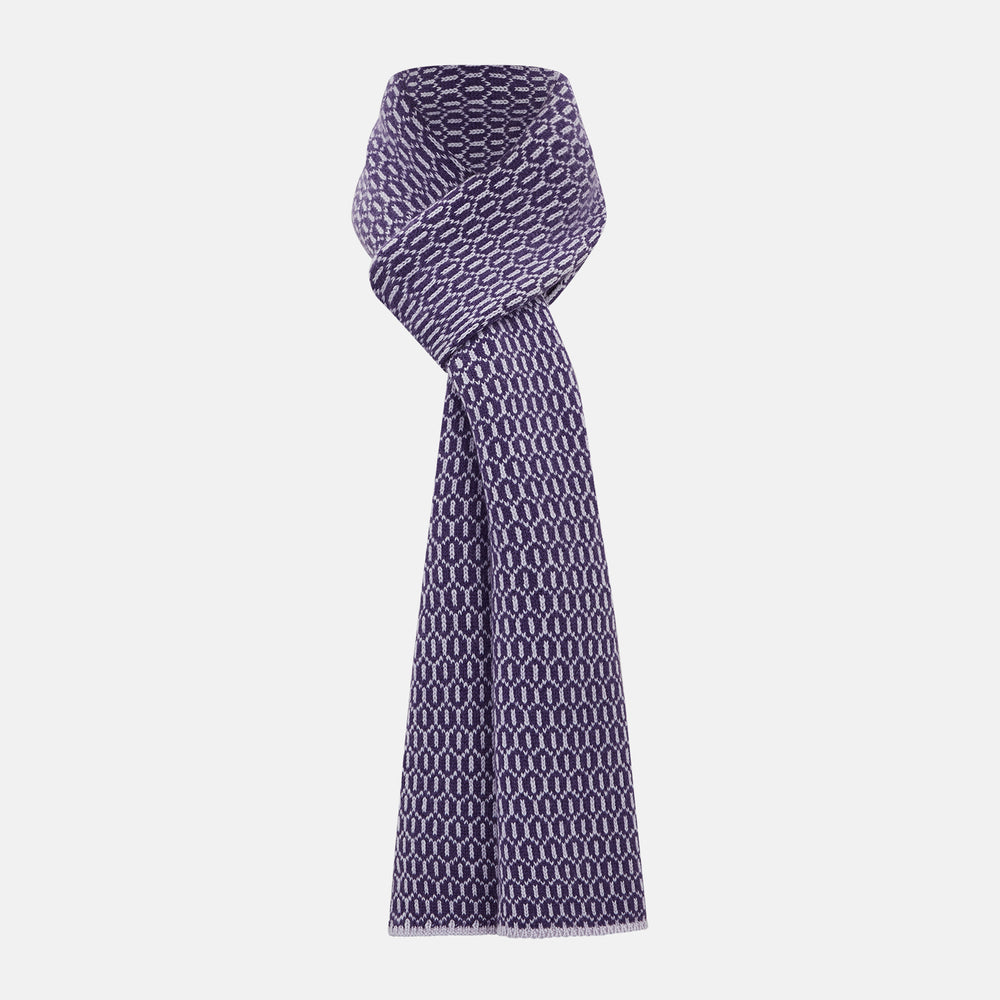 The Turnbull & Asser Purple and Lilac Hexagon Cashmere Knitted Scarf, featuring a white hexagon pattern, is neatly knotted and displayed on a plain background—a stylish accessory to elevate any outfit.