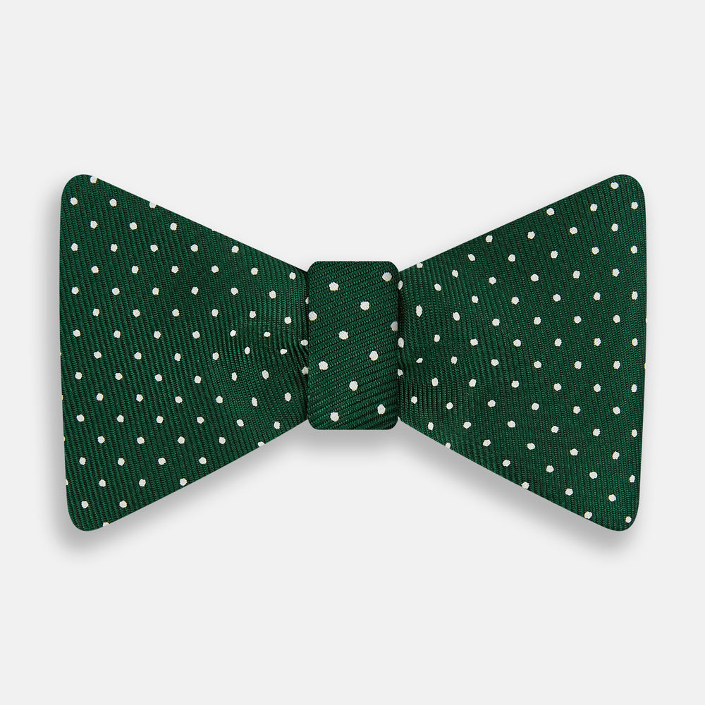 The Turnbull & Asser Racing Green and White Spot Silk Bow Tie features small white polka dots on luxurious silk, shown against a plain white background.