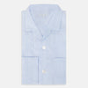 View 5 of product The Turnbull & Asser Pale Blue Linen Pyjama Shirt features long sleeves, a collar, front buttons, and a chest pocket—perfect as elegant loungewear or nightwear.