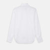 View 10 of product The White Cotton Lauren Shirt by Turnbull & Asser, featuring a stand collar, button-down front, and elongated body, is laid flat on a plain white background.